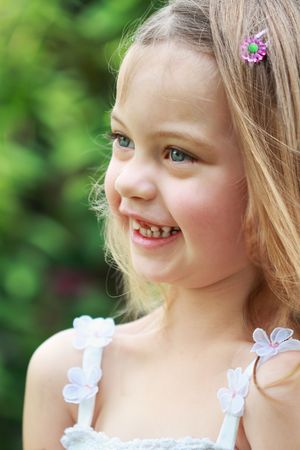 Portrait of a laughing little girl in the sunlight.の写真素材