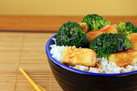 Vegetarian Stir Fry dish of crispy tofu, broccoli and orange sauce with chopsticks. Shallow DOF.の写真素材