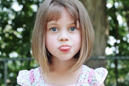 Child sticking out her tongue.
