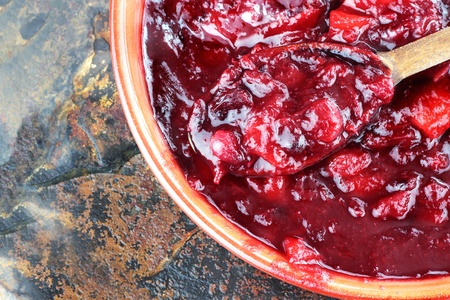 Fresh cranberry relish or sauce being stirred with a wooden spoon.の写真素材