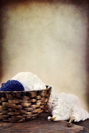 Basket of soft balls of yarn with needlework and knitting needles lying nearby. Room for copy space.
の写真素材