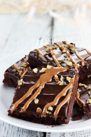 Close up plate of brownies with nuts and caramel sauce の写真素材