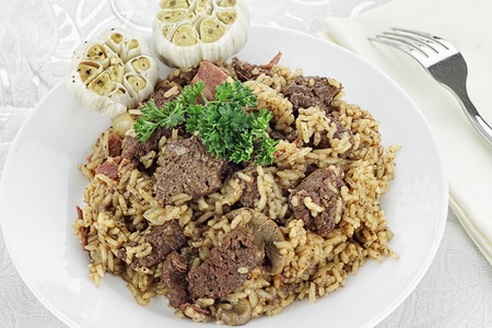 Venison Pilaf made with vension, bacon and mushrooms. Served with roasted garlic cloves. Could also be used as Beef Pilaf. Shallow depth of field.の写真素材