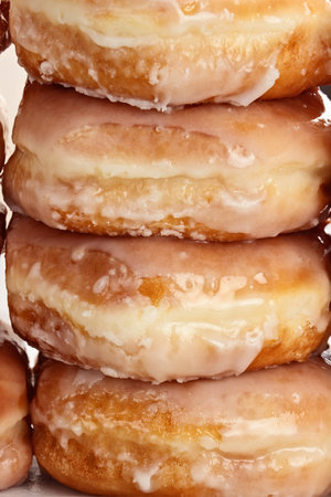 Stacked of delicious glazed donuts.の写真素材