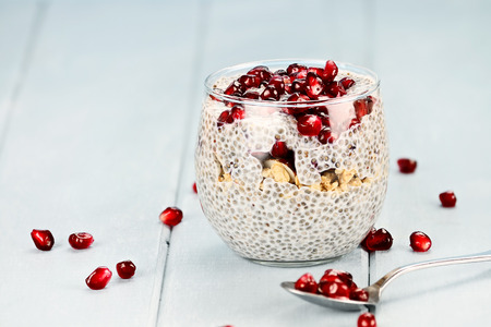 Chia seed parfait made with pomegranate, oats and almonds with extreme shallow depth of field.の写真素材