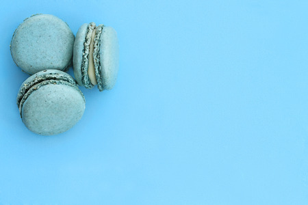 Blue macarons over blue background with room for copy space.の写真素材
