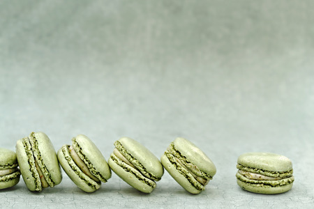 Pistachio flavored macarons with extreme shallow depth of field and copy space.の写真素材