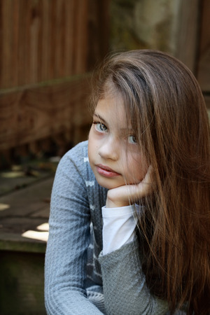 Young girl looking directly into the camera with long flowing hair. Extreme shallow depth of field.の写真素材