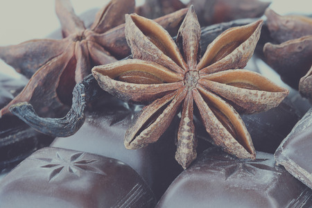 Close up of Star of Anise, Chocolate bars and Vanilla pods. Extreme close-up with shallow depth of field. Selective focus on center of Anise star.の写真素材