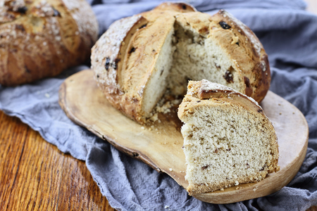 Slice of Irish soda bread in a rustic setting on an old wood table top.の写真素材