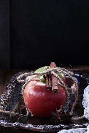 Fresh apples with cinnamon and star of anise. Shot in a dark moody atmosphere.の写真素材