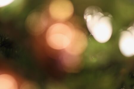 Abstract background of blurred green and red Christmas tree lights bokeh circles for holiday background.の写真素材