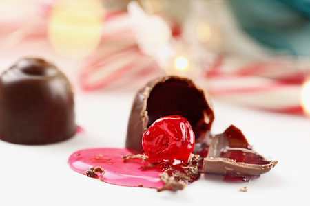 Chocolate covered cherries. Shallow depth of field with selective focus on bitten portion of candy...