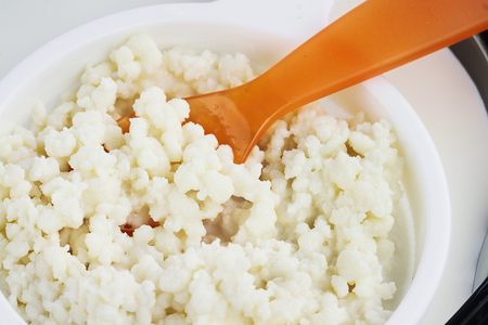 Mesh strainer of fresh Kefir grains. Kefir is one of the top health foods available providing powerful probiotics.  It is cultures of yeast and bacteria use to make a fermented milk product.の写真素材