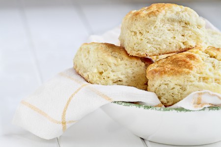 Fresh buttermilk southern biscuits or scones from scratch in a white bowl.の写真素材