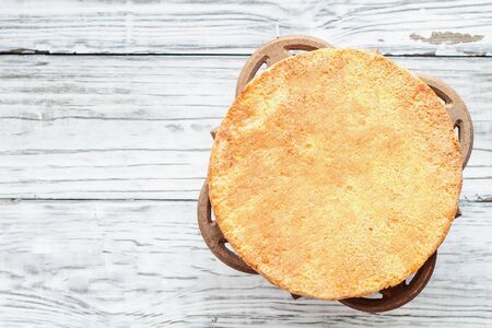 Naked Victoria Sponge Cake with cake stand over a white wooden rustic table top. Image shot for above.の写真素材