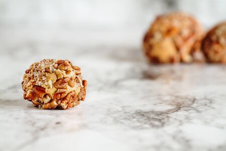 Keto pumpkin pie fat bombs. Made with pumpkin, pecan nuts, coconut oil and other fats..Selective focus with blurred background. Ketogenic diet conceptの写真素材