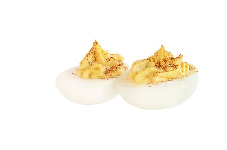 Two deviled egg halves sprinkled with paprika and isolated over a white background. Clipping path included.の写真素材