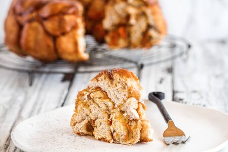 Easter dessert of Pull Apart Carrot Cake Monkey Bread. A yeast bundt cake made with cinnamon, carrots, nuts and a brown sugar glaze. Selective focus with blurred foreground and background.の素材 [FY310142027200]