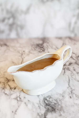 Homemade turkey gravy in a gravy boat or sauceboat ready for Thanksgiving Day.
