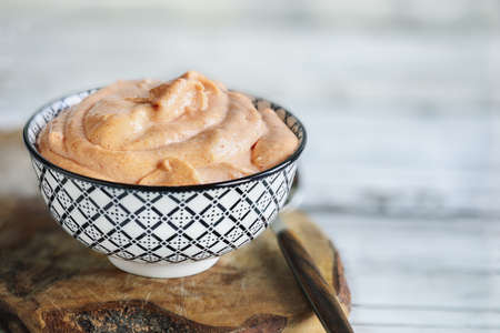 Japanese American yum yum sauce made with mayo, sugar, paprika, ketchup, rice vinegar, butter, onion powder, garlic powder and mirin.  Selective focus with blurred foreground and background.の写真素材