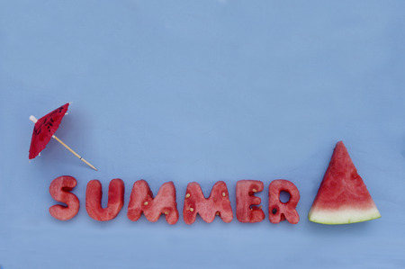 word summer in watermelon letters in on blue backgroundの写真素材