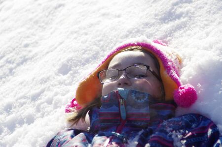 girl laying in snow