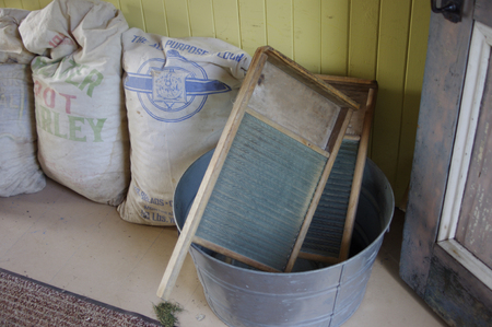 Antique washboards with flour sacks on floor