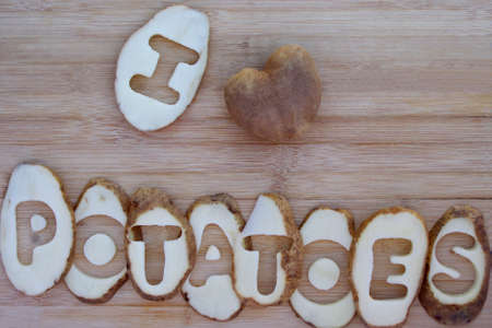 I love potatoes words with heart shaped potato on wood backgroundの写真素材