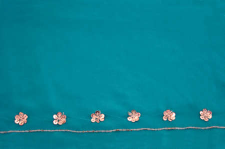rhinestone clear flower boarder detail jewels on turquoise green sari with copy spaceの写真素材