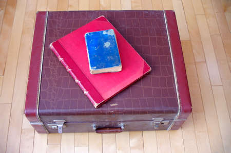 antique red and blue books on vintage brown leatherの写真素材