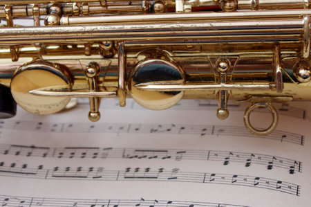closeup of gold saxophone on sheet musicの写真素材