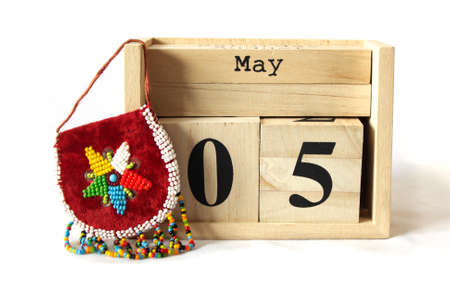 May 5th wooden calendar with beaded coin purseの写真素材
