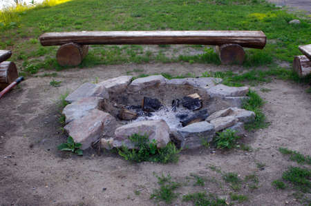 empty fire in with wooden benches on the beachの写真素材