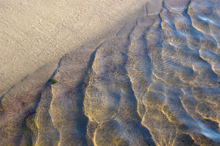 waves on sandy beach with copy spaceの写真素材