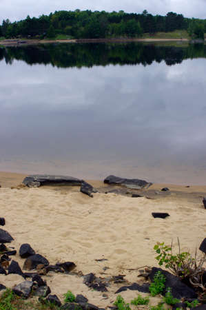 rocks on sandy beach in summer with copy spaceの写真素材