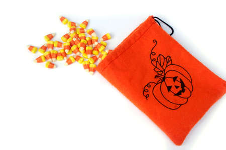 orange pumpkin bag with Halloween candy cornの写真素材