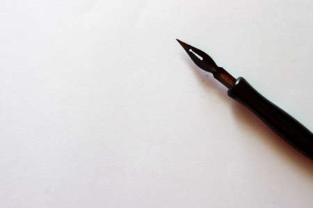 black fountain pen on white paper with copy spaceの写真素材