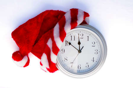 silver clock showing 10 minutes to midnight with Christmas Santa hat onの写真素材