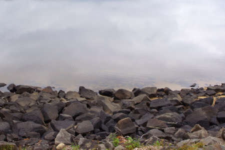 rocky shore at still water with copy spaceの写真素材