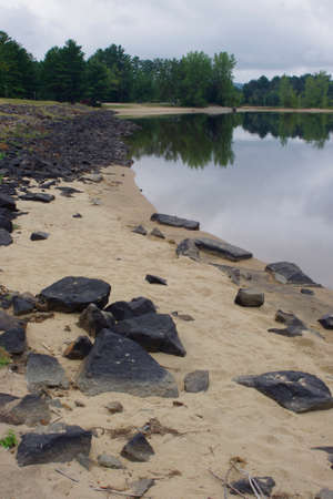 rocks on sandy beach in summer with copy spaceの写真素材