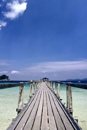 Wooden Jetty on a tropical beach on Tioman island, Malaysiaの写真素材