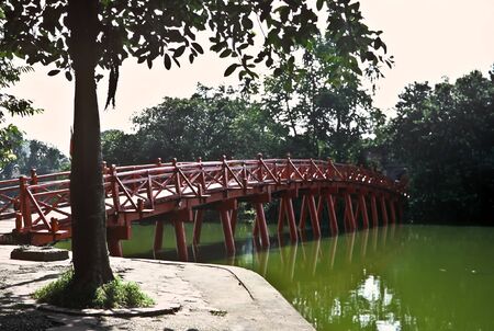 Red wooden bridge in a park in Hanoi, Vietnamの写真素材