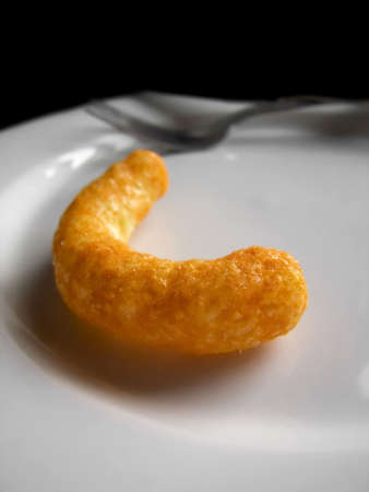 A bright orange cheese puff on a plateの写真素材