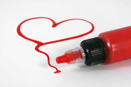 A red painted heart with paint bottle on white
の写真素材