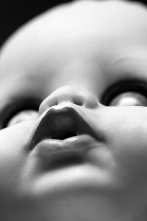 An artistic black and white photo of a doll's faceの写真素材