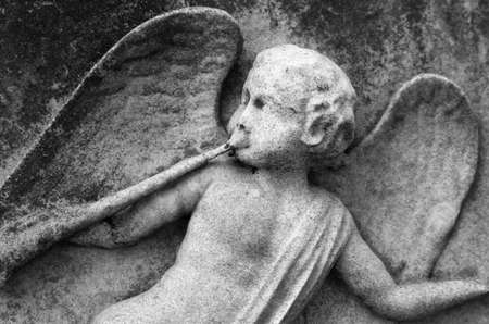 A close up of an angel playing a horn - gravestone carvingの写真素材