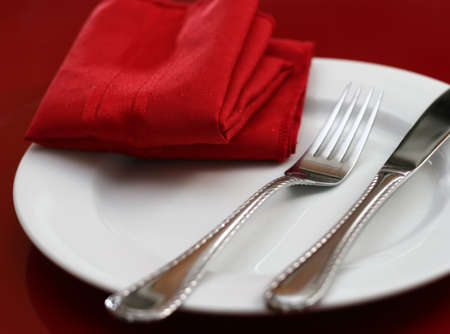 An elegant holiday table setting in red and whiteの写真素材
