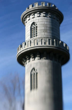 A castle tower against a blue sky with soft focus and lens blurの写真素材