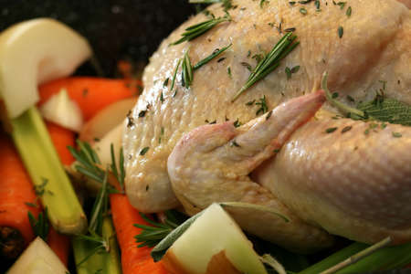 Healthy free range chicken and vegetables ready for roastingの写真素材
